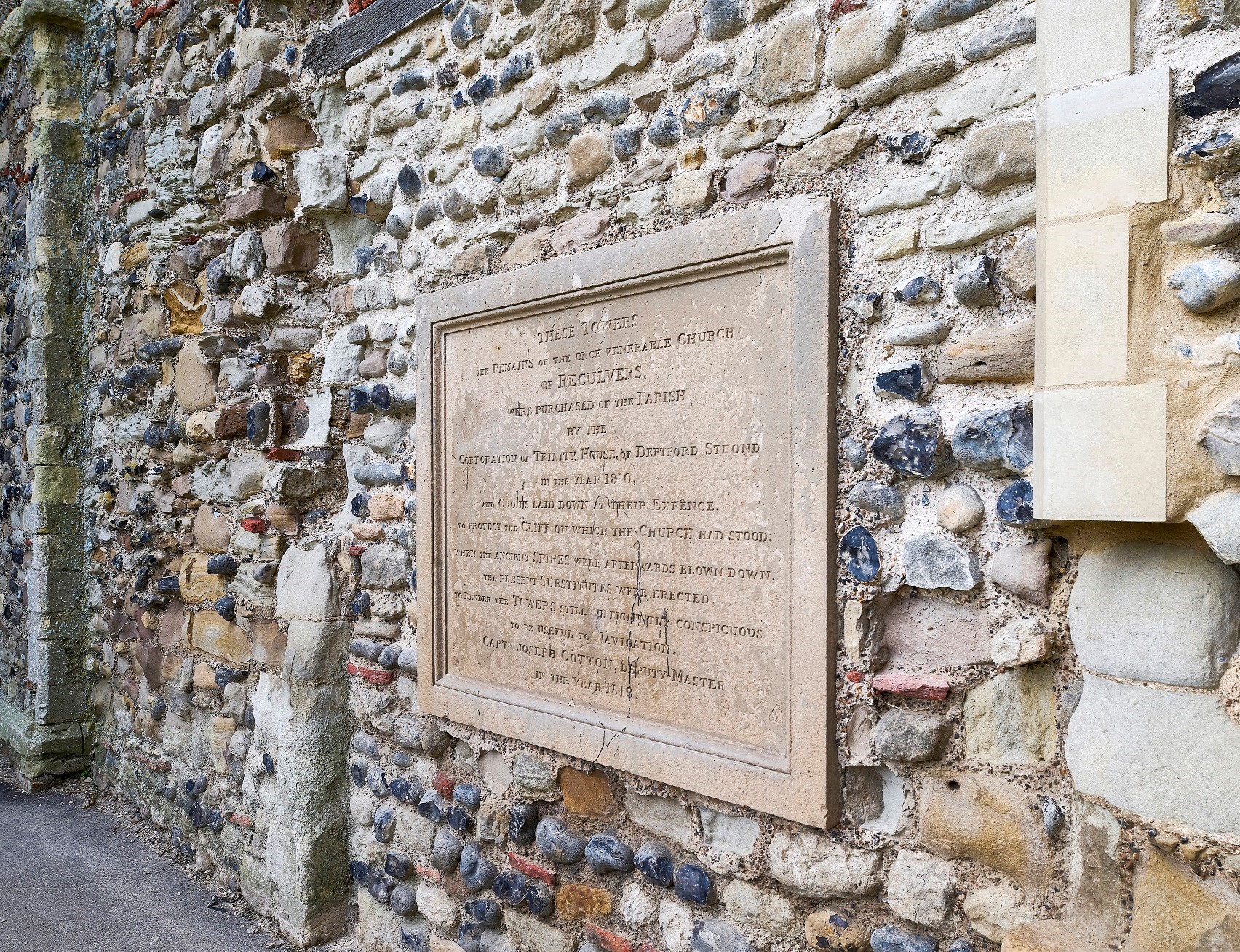 Photo of a stone plaque on a wall at Reculver Towers and Roman Fort