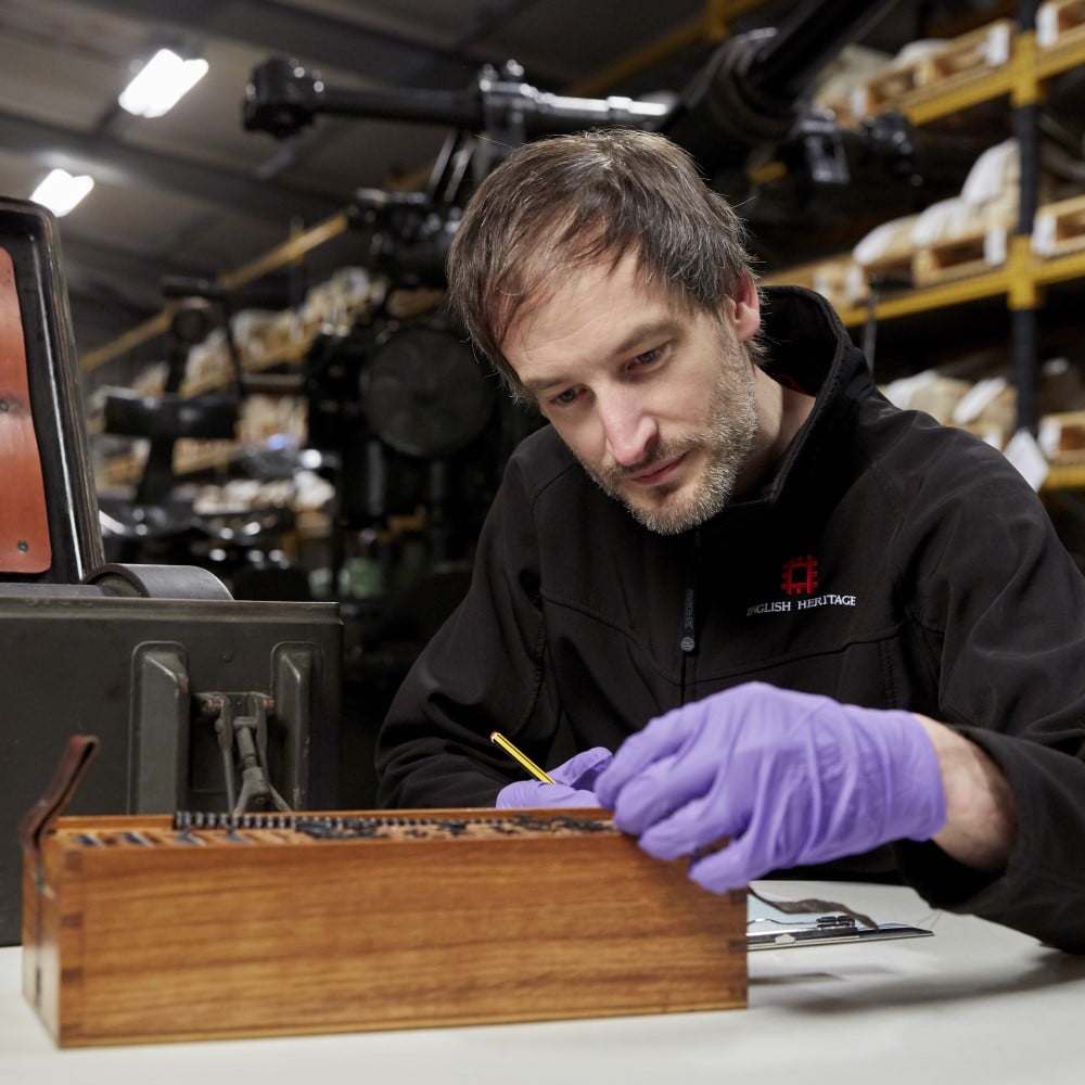 Photo of Curator of Collections Ian Leins examining an object at Temple Cloud in Somerset