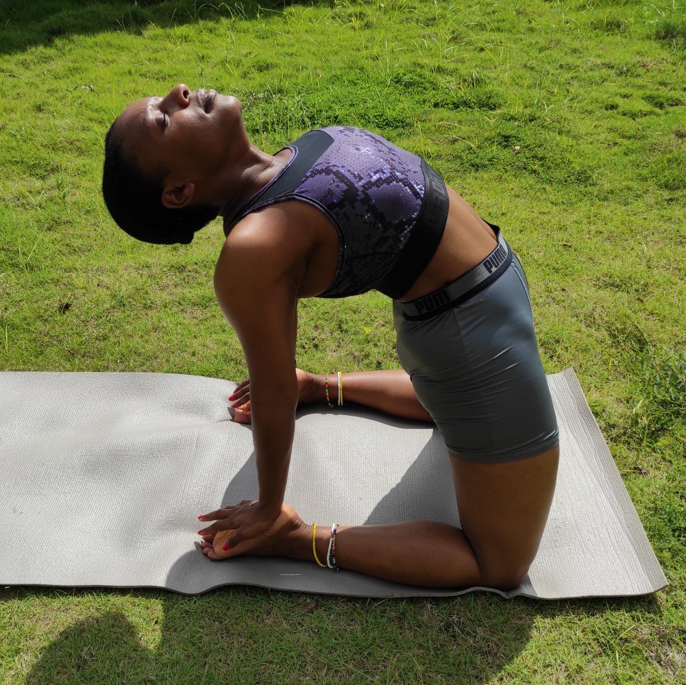 Photo of someone doing yoga outdoors on a sunny day