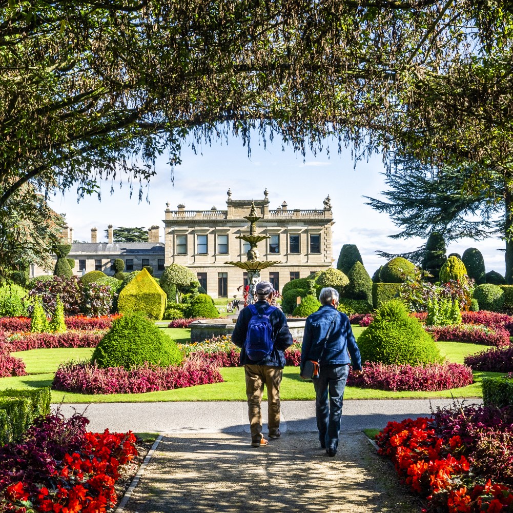 Photo of two people walking through the colourful gardens at Brodsworth Hall and Gardens on a sunny day