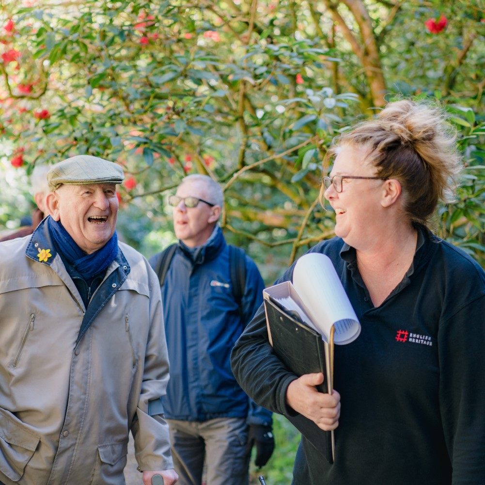 Photo of Belsay Hall, Castle and Gardens' Head Gardener sharing a joke with a visitor in the gardens