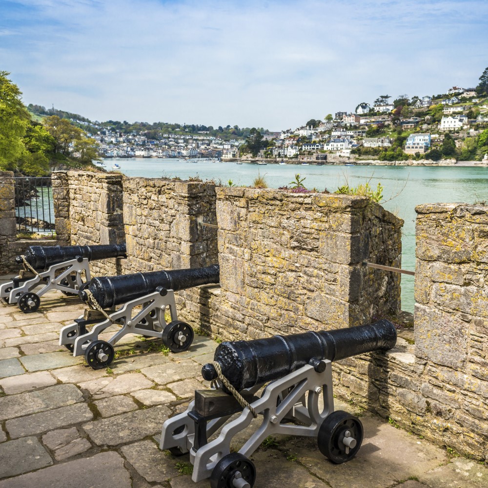 Photo of cannon along the ramparts of Dartmouth Castle on a sunny day