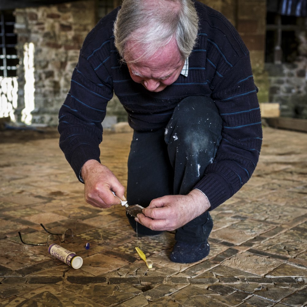 Photo of someone gluing a mosaic tile at Cleeve Abbey